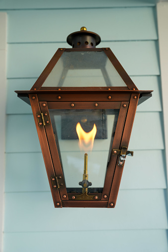 Exterior light fixture with glowing natural gas flame
