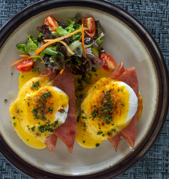 istock Eggs Benedict featuring ham, accompanied by a garden green salad 1817771186