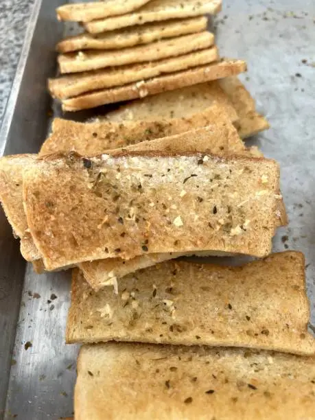 bread slices with butter and toasted on white marble kitchen table