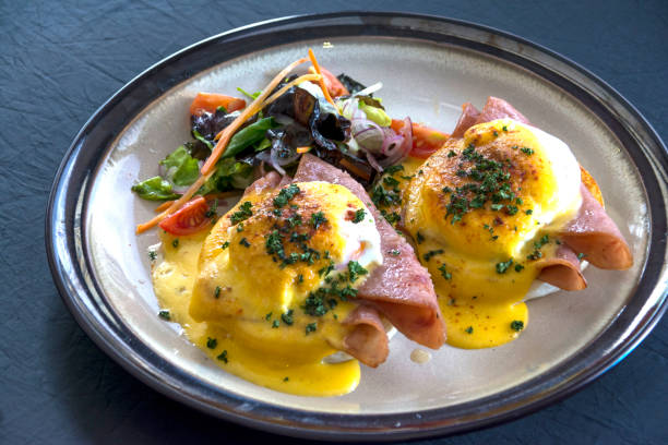 istock Eggs Benedict featuring ham, accompanied by a garden green salad 1817796737