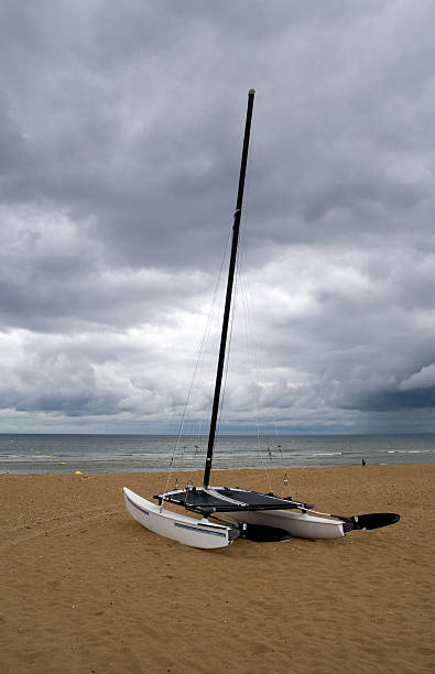 Catamaran sailboat on a beach stock photo