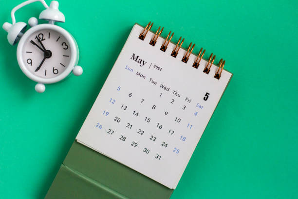 Desk calendar for May 2024 on a green background.