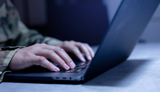 istock close up soldier man hand typing on keyboard laptop to check and use command for military operation test system in office room concept 1817840153