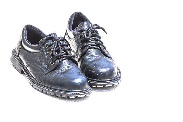 istock Old Black Shoes on white Background 181786460