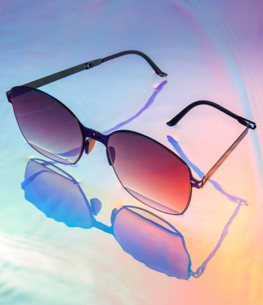 istock Folding sunglasses, indoor photography light, colorful background, gradient color combination, sunglasses, portable and foldable design concept 1817882529