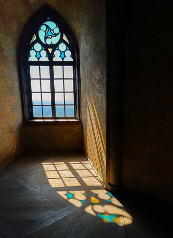 quiet room with atmospheric light through a leaded glass window