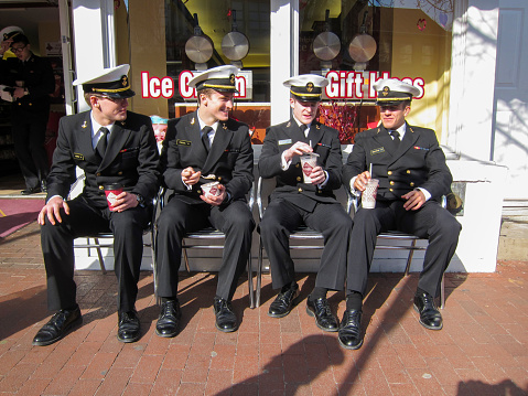 Four midshipmen of the US Naval Academy relax and have some ice cream in the City Dock area of Annapolis MD