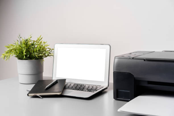 istock Printer and laptop on grey table in office 1817915993