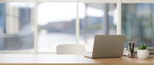 istock Laptop computer on a table in minimal modern living room. Home workspace, closeup image 1817939690