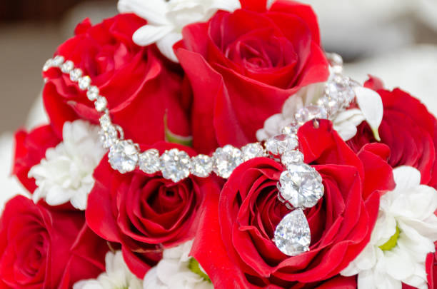 istock Wedding Rings on a rose bouquet 1817940473