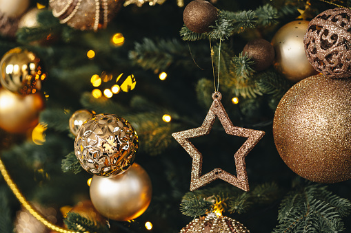 Beautiful Christmas tree with golden balls decor close up photo