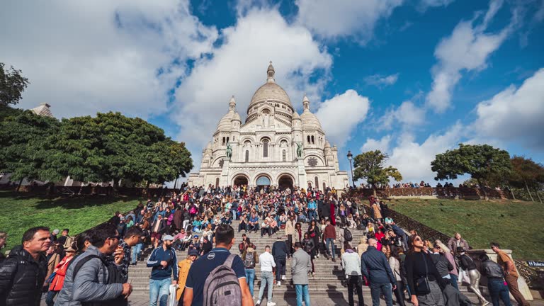 Time lapse of Crowd of People tourist walking and sightseeing attraction Basilica of the Sacred Heart at Montmartre a large hill in Paris's northern in summer, France