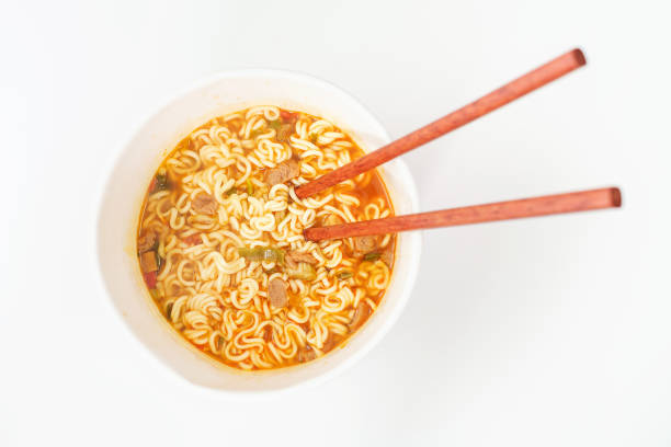 istock A bowl with ready ramen and wooden sticks on white background, top view. 1817982338