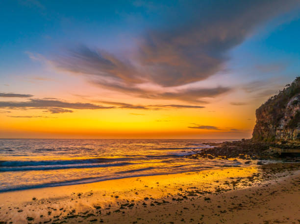 istock Sunrise at the seashore with clouds 1818007869