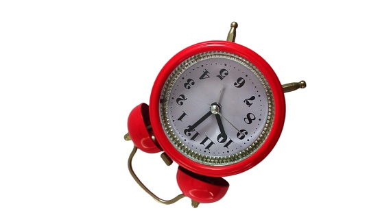 red alarm clock on white background. red old style alarm clock isolated on white