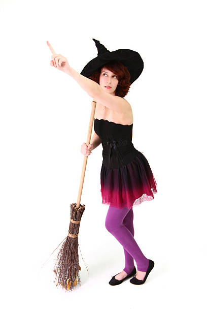 istock Halloween witch with broom and pointing finger up isolated 181803340