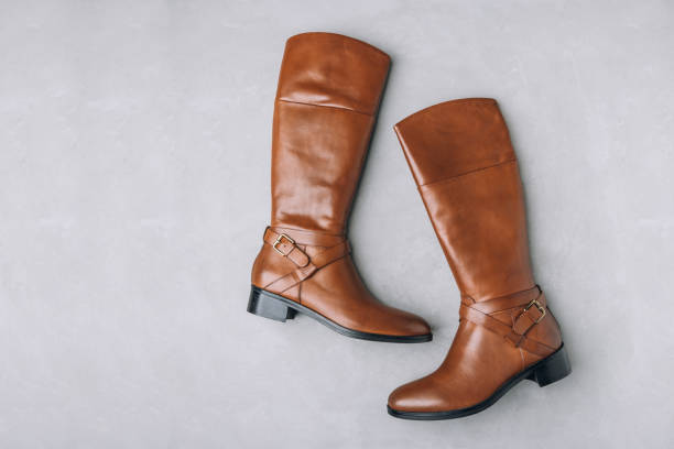 istock Boots. Women's brown leather high long boots on gray background. Top view. 1818042229