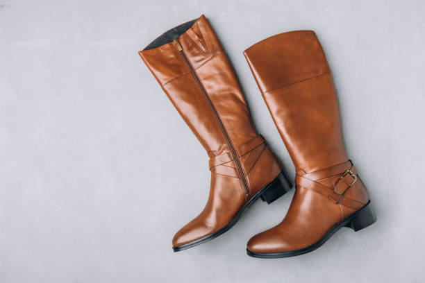 istock Boots. Women's brown leather high long boots on gray background. Top view. 1818042485