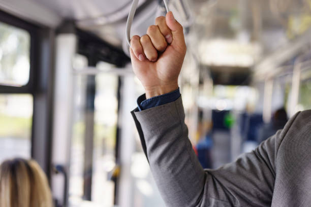 istock Close up of a businessman holding for a bus handle. 1818051202