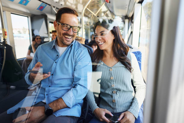 istock Happy couple talking while enjoying in their travel by a bus. 1818054865