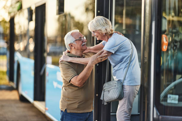 istock Happy senior couple greeting by the bus. 1818058043