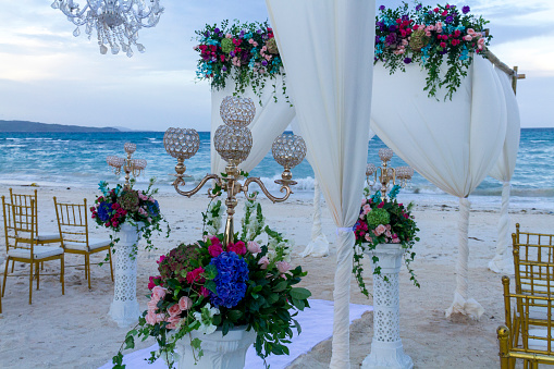 A beachfront wedding ceremony arranged with a romantic setup