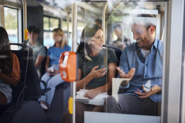 istock Young happy couple talking while traveling by public transportation. 1818063365
