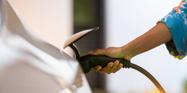 istock Female and charging electric car 1818063913