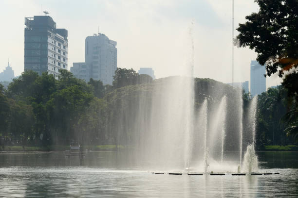 istock Fountain in the middle of a park with a pond 1818065021