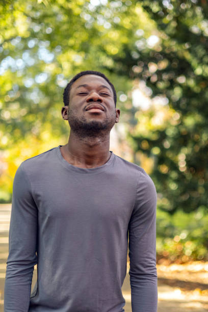 istock Man doing breathing exercise in the park 1818076674