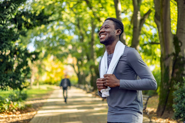 istock Smiling man runner holding towel around neck 1818077252