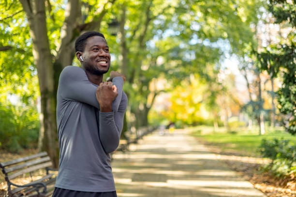 istock Sporty man starting his exercise routine with stretching exercises 1818077368