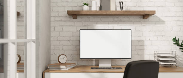 istock A minimalist white office desk workspace with a computer on a wood table against a white brick wall. 1818083886