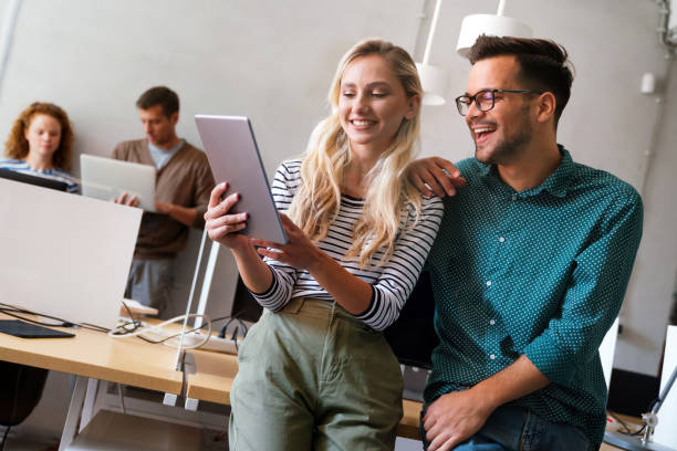 istock Two young businesspeople using a digital tablet while standing in a boardroom. 1818115510