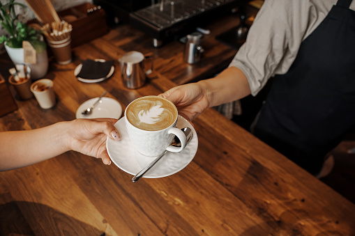 Handoff of a Cappuccino at Coffee Shop