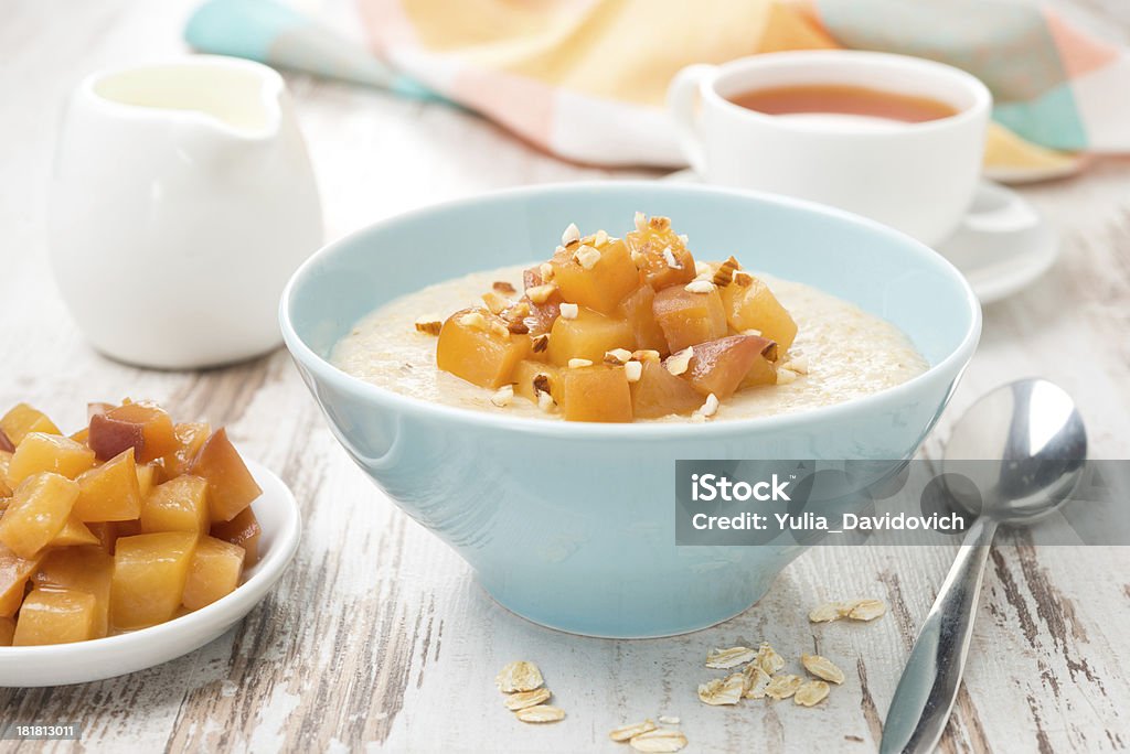 oatmeal with caramelized peaches, tea and yogurt oatmeal with caramelized peaches, tea and yogurt, close-up Bowl Stock Photo