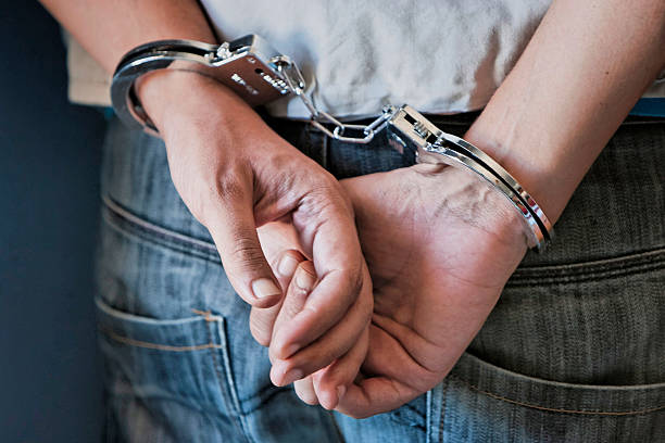 Young man in handcuffs stock photo