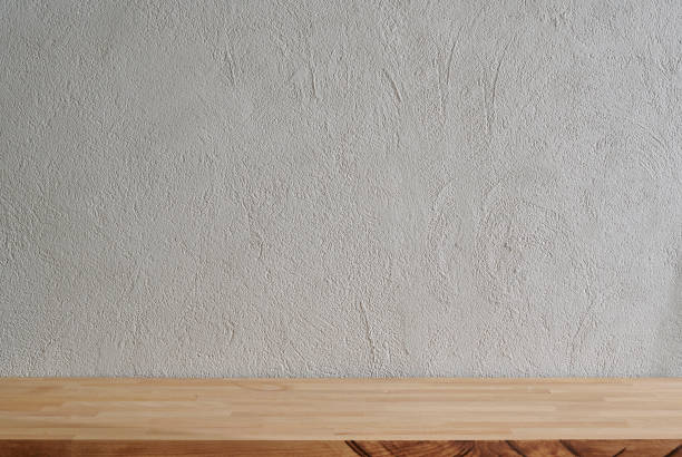 istock Grey stone wall background and wooden table close up, empty. 1818134379