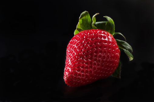 strawberry on black background, macro