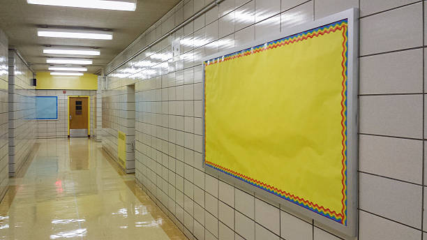 empty school hallway with bulletin board stock photo