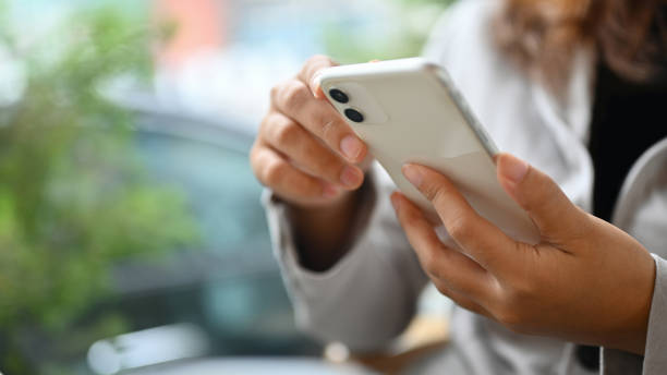 istock Young woman using mobile phone typing messages or communicating in social network 1818159342