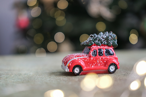 Red toy Christmas car with Christmas tree