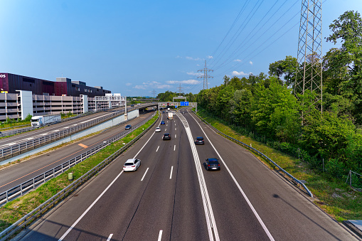 Highways and highway interchange with car and truck traffic seen from above in spring.