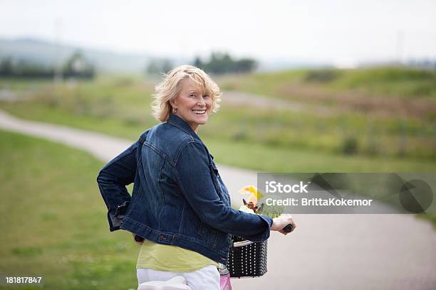 Senior Woman Riding A Bicycle Stock Photo - Download Image Now - Denim Jacket, Mature Women, 50-59 Years