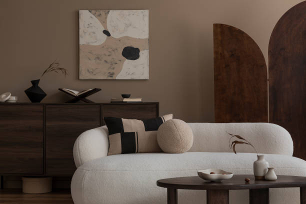 istock Creative composition of living room interior with mock up poster frame boucle sofa, stylish coffee table, wooden sideboard, partition wall, pillows and personal accessories. Home decor. Template. 1818183207