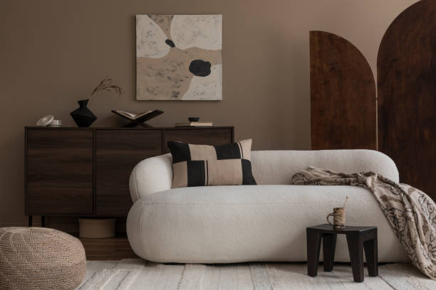 istock Creative composition of living room interior with mock up poster frame boucle sofa, stylish coffee table, wooden sideboard, partition wall, pillows and personal accessories. Home decor. Template. 1818183766