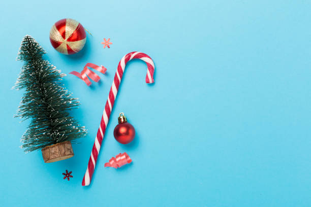 istock Miniature christmas tree with gift box and decor on color background 1818189171