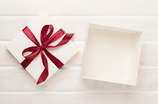 Open gift box on wooden background, top view. Mock up for design