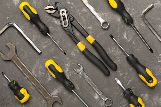 Set of tools on concrete background, top view