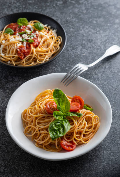 istock Pasta, spaghetti with tomato sauce in black bowl and white bowl 1818209644